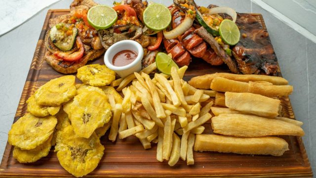 a wooden platter filled with different types of food